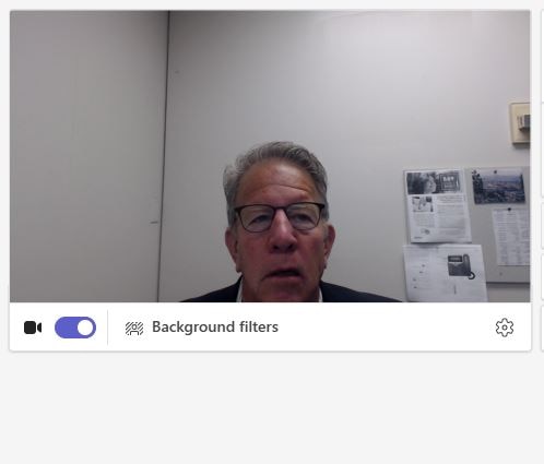 Before: a Microsoft Teams preview showing a man in glasses under flat light, in front of a washed-out wall with papers pinned behind him.