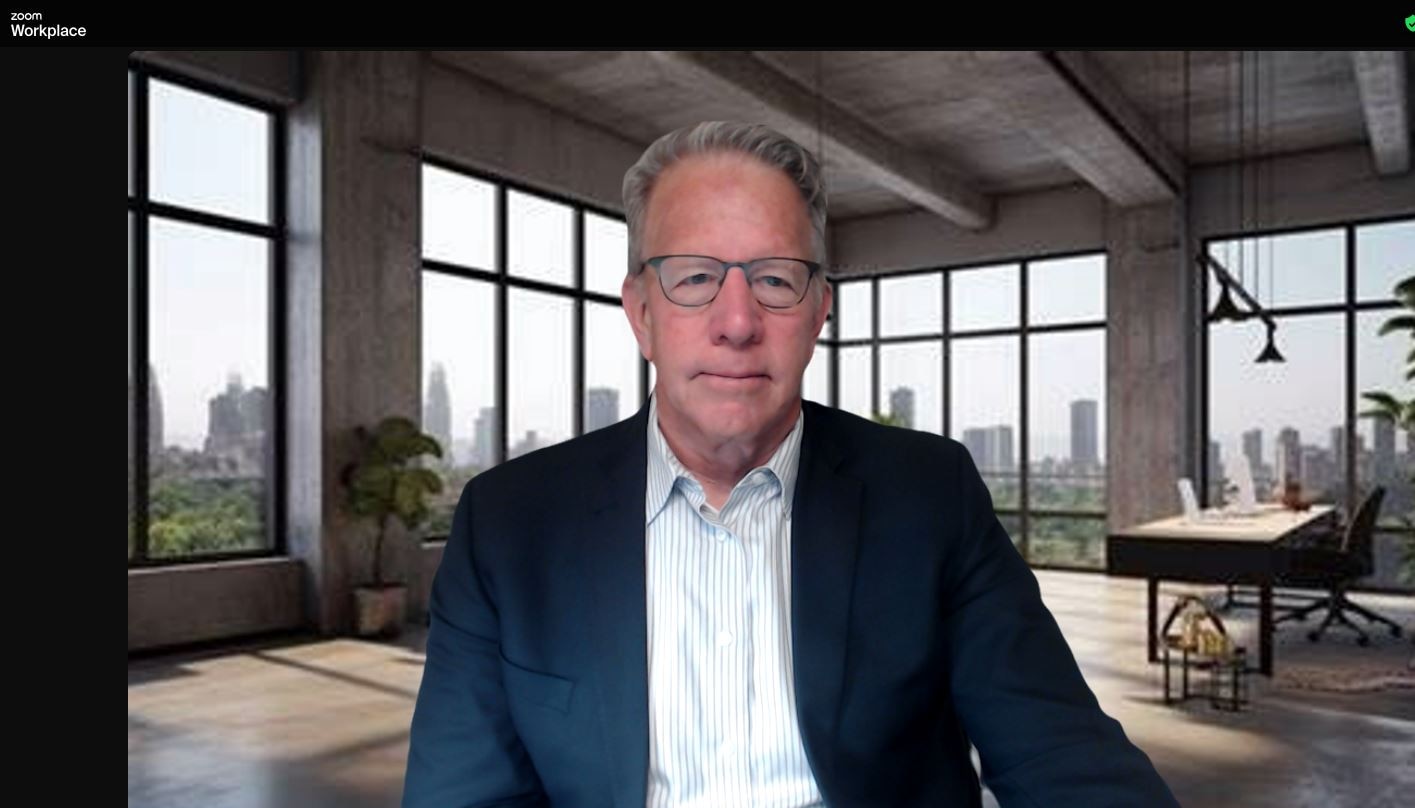 After: a Zoom call showing the same man in a navy blazer, evenly lit, in front of a modern loft background with tall windows.